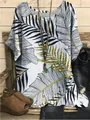 Close-up detail of casual loose short-sleeved top featuring tropical gold leaf prints - S / Tops / Black (Palm Leaf Print - Fig 29)