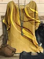 Close-up detail of loose women's tunic with yellow wavy graphic print on linen texture. - S / Tops / Mustard Yellow (Abstract Wave Print - Fig 20)