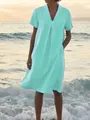 Detail view of a woman wearing a mint green V-neck cotton linen dress on a beach at sunset - S / Top And Bottom / Light Green