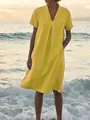Detailed view of yellow cotton linen V-neck dress with pockets in summer beach setting - S / Top And Bottom / Yellow
