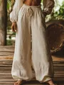 Close-up detail of off-white wide-leg linen pants featuring elastic drawstring waist and pockets - S / Bottoms / Apricot