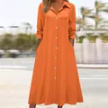Detailed view of women's bright orange long-sleeved shirt dress with lapel and pockets - S / Tops / Orange