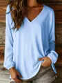 Detail view of light blue V-neck blouse with elastic cuffs and loose fit. - S / Tops / Light Blue