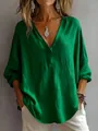 Detail view of the green V-neck blouse showing textured fabric and loose fit - S / Tops / Green