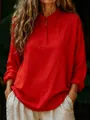 Detailed view of women's loose red long-sleeve cotton blouse with buttoned collar - S / Tops / Red