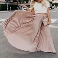 Elegant dusty rose pleated maxi skirt with flowing fabric in an urban street setting - Pink and Red