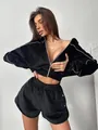 Chic black velvet two-piece set featuring a zip-up cropped jacket and high-waist shorts - Black