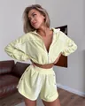 Close-up of pale yellow velvet two-piece set featuring a zipper cardigan and matching shorts - Yellow