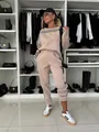Detailed view of the stylish women's beige tracksuit set with black and white side stripes - S / Top And Bottom / Khaki