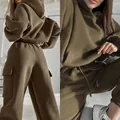 Detailed close-up view of olive green hoodie and cargo sweatpants set with pocket details - S / Top And Bottom / Khaki