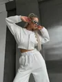 Stylish white two-piece lounge set featuring cropped zip-up hoodie and high-waist pants - White