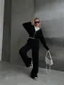 Full body view of a stylish black zip-up hoodie and matching wide-leg sweatpants set - Black