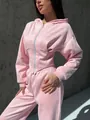 Close-up view of a pink velvet two-piece tracksuit set with corset waist zip-up hoodie - S / Top And Bottom / Pink