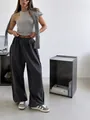 Detail view of dark gray wide-leg sweatpants with elastic waist for casual street style. - S / Bottoms / Dark Gray