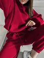 Detailed view of women's red hoodie and matching joggers set in vibrant color - S / Top And Bottom / Red