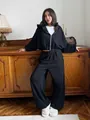Model wearing black cropped zip-up hoodie and matching wide-leg tracksuit bottoms - S / Top And Bottom / Black