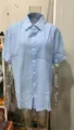 Detail of light blue short-sleeved linen shirt with chest pocket and button-down front. - S / Tops / Sky Blue