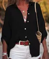 Gros plan d'une chemise noire en lin pour femme, coupe ample avec boutons blancs discrets - Noir
