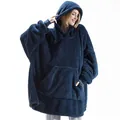 Cozy texture detail of a navy blue fleece wearable blanket hoodie on a female model - One Size / Tops / Navy Blue