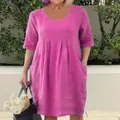 Detail view of a fuchsia linen-style dress featuring a round neck and convenient pockets - S / Top And Bottom / Rose Red