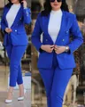 Detail view of a royal blue professional women's blazer suit set with gold buttons. - S / Top And Bottom / Sapphire Blue