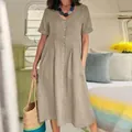 Detailed view of loose high-waist cotton linen dress in casual camper setting - S / Tops / Khaki