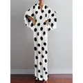 Detail view of retro white maxi dress with large black polka dots and V-neck line - Large Polka Dot