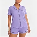 Close-up detail of women's purple modal pajama set featuring black piping and heart embroidery - Purple