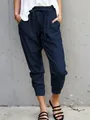 Close-up of navy blue cotton linen casual drawstring pants with a slim fit ankle-length cut. - Navy Blue