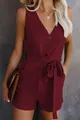 Detail of burgundy V-neck romper with button front and adjustable bow belt. - Burgundy