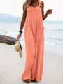 Casual orange sleeveless wide-leg jumpsuit worn by a model on a sunny beach scene - S / Top And Bottom / Coral
