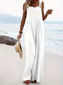 Full length view of an elegant white sleeveless wide-leg jumpsuit worn on a sunny beach - S / Top And Bottom / White