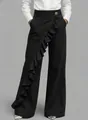 Detailed shot of black high-waisted denim trousers with asymmetrical ruffle - 3XL / Bottoms / Black