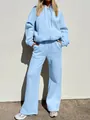 Outdoor full body view of woman wearing oversized light blue two-piece tracksuit set - S / Top And Bottom / Light Blue