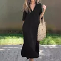 Elegant detail of a black V-neck summer dress featuring 3/4 sleeves and side slits. - S / Top And Bottom / Black