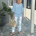 Full view of women's blue round neck top and floral print trousers set - XS / Top And Bottom / Light Blue Leaf Print (02)