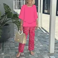 Close-up of women's two-piece set with pink tiered top and floral print trousers - XS / Top And Bottom / Peach Red Floral Print (12)