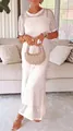 Detail of a white hollow-out crochet 2-piece maxi dress worn by a model in a cozy setting - White