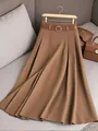 High-quality detail of a brown pleated midi skirt featuring a coordinated belt and gold buckle - 2XL / Bottoms / Brown
