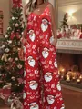 Close-up of festive red Christmas jumpsuit featuring Santa Claus and Ho! Ho! prints - Christmas Red and White Santa
