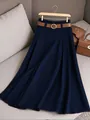 High-quality detailed view of a navy pleated A-line skirt with a brown belt on a grey sofa - 2XL / Bottoms / Dark Blue