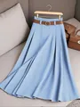 Close-up view of a light blue solid color pleated midi skirt with brown belt detail - 2XL / Bottoms / Light Blue