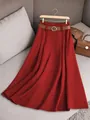 Close-up detail of a dark red pleated midi skirt featuring a brown leather waist belt - 2XL / Bottoms / Red