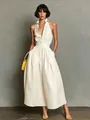 Detailweergave van een elegante mouwloze crèmekleurige maxi-jurk met overhemdkraag - Melkwit
