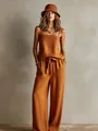 Model wearing a stylish terracotta two-piece set with cami top and wide-leg trousers - S / Top And Bottom / Tan