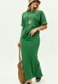Full view of a model wearing a green casual two-piece set with loose top and long skirt. - Green