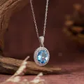 Macro close-up view of S925 silver necklace with oval blue topaz pendant and halo stones - Natural Topaz Pendant (With Chain)