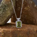 Close-up of rectangular green gemstone pendant with silver halo on rock background - Natural Peridot / Natural Peridot Pendant With Necklace