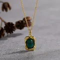 Close-up of vintage gold-plated malachite pendant with hammered texture detail - Malachite-Gold