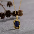 Close-up of vintage S925 silver necklace with oval lapis lazuli in textured gold frame - Lapis Lazuli-Gold